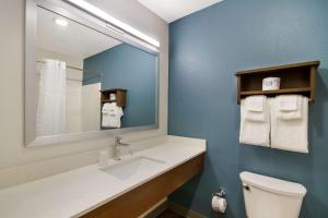 巴拿马城海滩WoodSpring Suites Panama City Beach的一间带水槽、镜子和卫生间的浴室