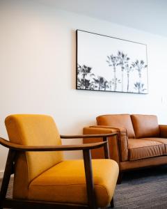 阿德莱德Peninsula Hotel Motel的一间带椅子、一张桌子和一张沙发的房间