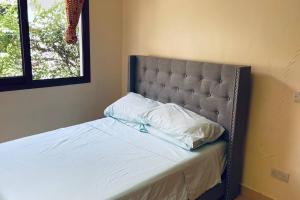 达累斯萨拉姆Romantic Mediterranean beach house的一张带床头板的床和两个枕头