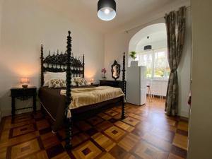 科英布拉Casa Anjos的一间卧室配有一张铺有木地板的床。