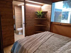 里帕尔贝拉Glamping Debbiare的一间卧室配有一张床,浴室设有卫生间