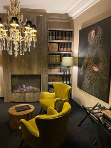 布鲁日't Hartje van Brugge的客厅设有黄色椅子和壁炉