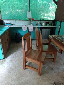BarrigonesCorcovado Guide House的厨房配有2把木椅和桌子