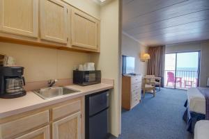 大洋城火烈鸟汽车旅馆的带水槽的厨房和1间带床的房间