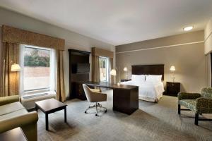 莫沃马瓦希尔顿恒庭旅馆&套房酒店的配有一张床和一张书桌的酒店客房