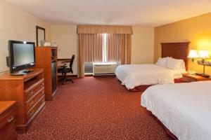 麦库姆麦库姆希尔顿恒庭旅馆&套房酒店的酒店客房设有两张床和一台平面电视。