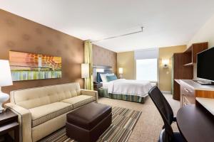 奥马哈奥马哈西部希尔顿惠庭套房酒店的酒店客房设有一张沙发和一张床