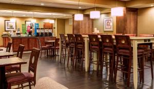彭德尔顿彭德尔顿汉普顿酒店的餐厅设有酒吧,配有桌椅