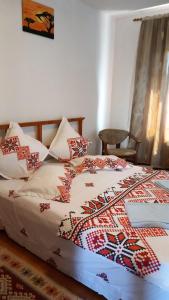 图尔恰CASA ADELA的一间卧室配有一张带被子和枕头的床
