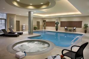 沃恩多伦多沃恩希尔顿惠庭套房酒店的一座大型游泳池,在酒店的房间内配有热水浴缸