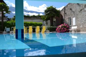 利莫内-苏尔加达圣路易吉公寓的享有带椅子和鲜花的游泳池的景色