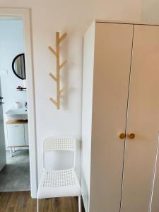 旧瓦马Daro tiny house的小房间设有白色椅子和衣柜
