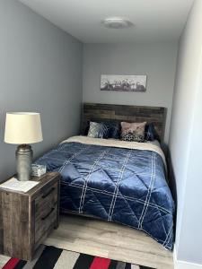 温尼伯Spotless 4 Bedrooms 4 Beds Sleep 8 in Winnipeg的一间卧室配有一张带蓝色棉被的床