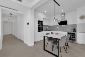 图彻皮Apartman DeLux with private pool的厨房以及带桌椅的用餐室。