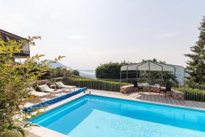 Villanuova sul clisiVilla Montagne & Lago by Garda FeWo的房屋旁带凉亭的游泳池