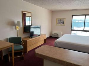 波卡特洛Motel 6 Pocatello ID的酒店客房,配有床和电视
