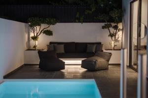 赫索尼索斯Hygge Suites的带沙发和游泳池的客厅