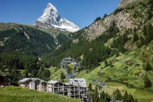 采尔马特Matterhorn FOCUS Design Hotel的山前有摩天轮的山