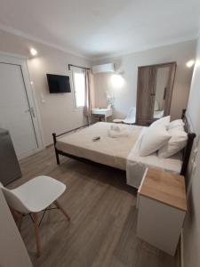 阿吉亚玛丽娜Elia Apartments的卧室配有1张床、1张桌子和1把椅子