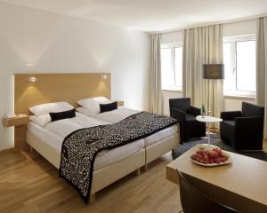 韦尔斯普罗波格酒店的酒店客房设有一张大床和一张桌子。