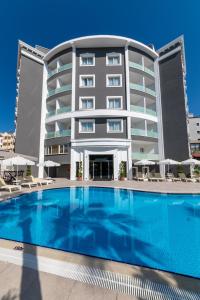 马尔马里斯Motto Premium Hotel&Spa的大楼前设有游泳池的酒店