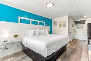 汉普顿Royal Crest Inn - Hampton Beach的一间卧室设有一张大床和蓝色的墙壁