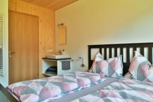 施科佩尔瑙Bergreich Appartement 2的一间卧室配有一张带被子和枕头的床