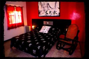莱佩Pensión El Alamo的一间卧室设有一张黑色的床和红色的墙壁