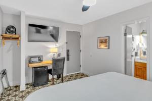 安克雷奇Highliner Hotel - Deluxe Interior King Rooms- No View的一间卧室配有一张床和一张带电脑的书桌