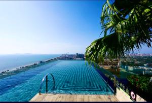 乔木提恩海滩LuxSL Luxury Style of Life 6的一座游泳池,位于一座毗邻大海的建筑的顶部