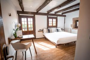 宏达瑞比亚阿洛特森尼亚乡村旅馆的卧室配有一张床和一张桌子及椅子