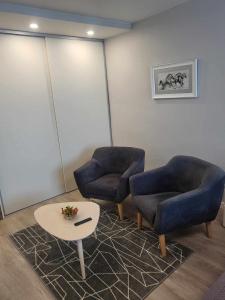 希奥利艾Vanilės home的一间设有两把椅子和一张桌子的等候室