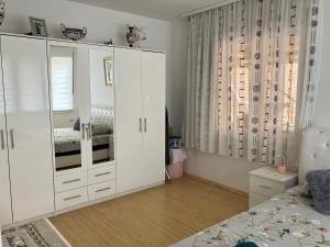 大格拉迪什泰Apartamani Evelin的卧室配有白色橱柜和1张床。