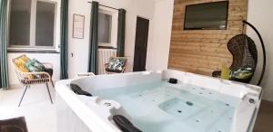 邦多勒Dream House & Spa Bandol - Céline et Olivier的带电视的客房内的白色大浴缸