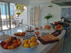伊斯基亚La Pergola del Torchio的厨房柜台,摆放着许多水果和糕点