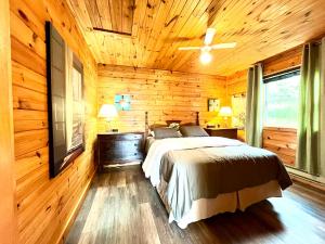 MiddletonStargazers Cove Cottages Otter的卧室配有木墙内的一张床