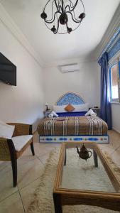 舍夫沙万家庭旅馆的一间卧室配有一张床、镜子和吊灯