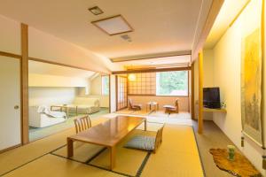 十日町Ryounkaku Matsunoyama onsen的客厅配有桌子和沙发