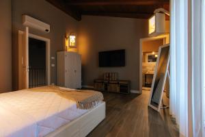 萨卢佐Agriturismo Agli ulivi的一间卧室配有一张床和一台平面电视
