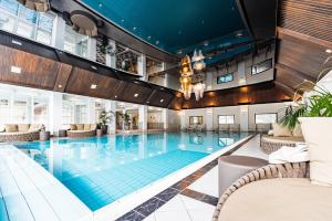 恩斯河谷艾根IMLAUER Hotel Schloss Pichlarn的一座配有桌椅的酒店游泳池