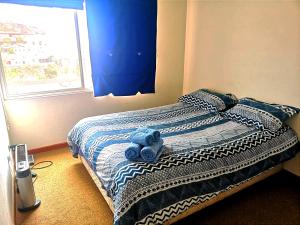 瓦尔帕莱索Valparaiso Primera Linea的卧室里床上的蓝色泰迪熊