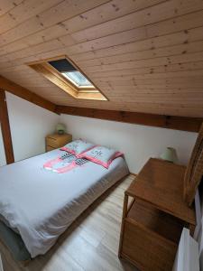 波讷地区圣朱利安Village Océlandes的一间卧室配有一张床和天窗