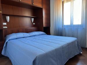 格拉多阿拉齐塔迪特里雅斯特酒店的一间卧室设有一张大蓝色的床和窗户