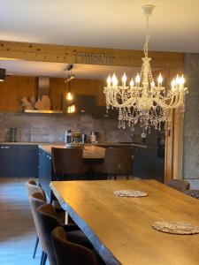 比桑Chalet le Bô & Spa的一间带桌子和吊灯的用餐室