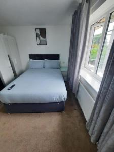 ThamesmeadImpeccable 2-Bed House in Thamesmead London的一张位于带窗户的房间的床