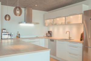 托尔斯港Breathtaking Views - New - 220m2 - 5 BR - Walks的厨房配有白色橱柜和不锈钢用具