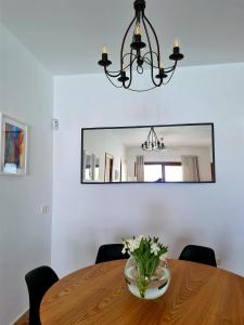 普拉亚布兰卡Villa Nitho - heated Pool, panoramic view, privacy的餐桌、镜子和花瓶
