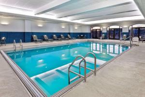 堪萨斯城乡村俱乐部广场汉普顿套房酒店的大楼内一个蓝色的大型游泳池
