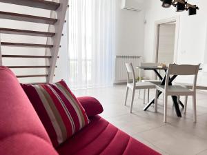 特拉尼TornaRé的客厅配有粉红色的沙发和桌子