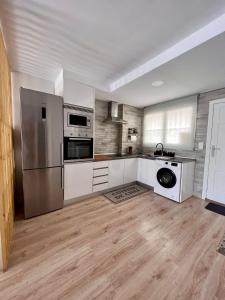阿利坎特Suite Bonalba的厨房配有不锈钢用具,铺有木地板